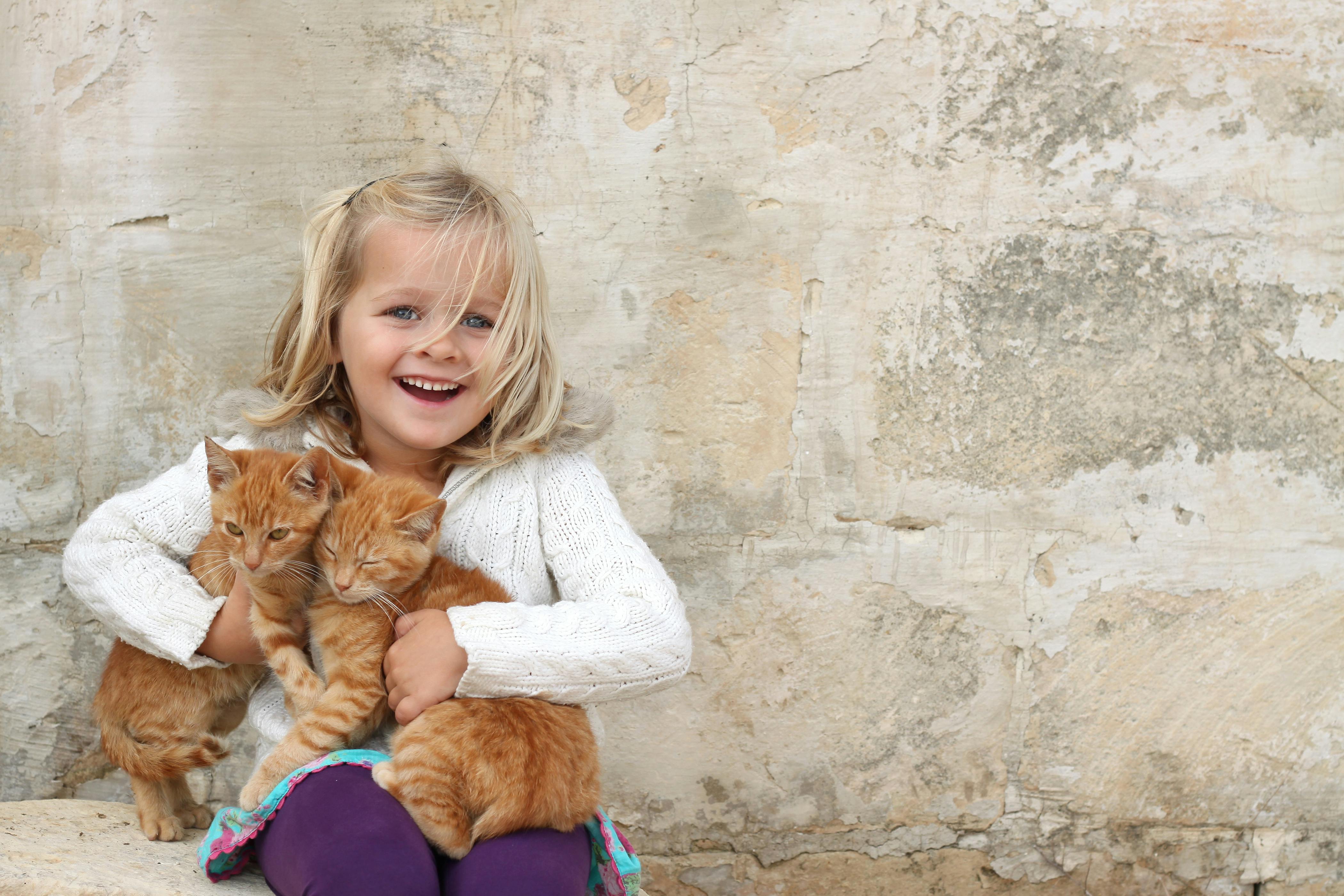 Blonde girl cats smiling happy.jpg?ixlib=rails 3.0