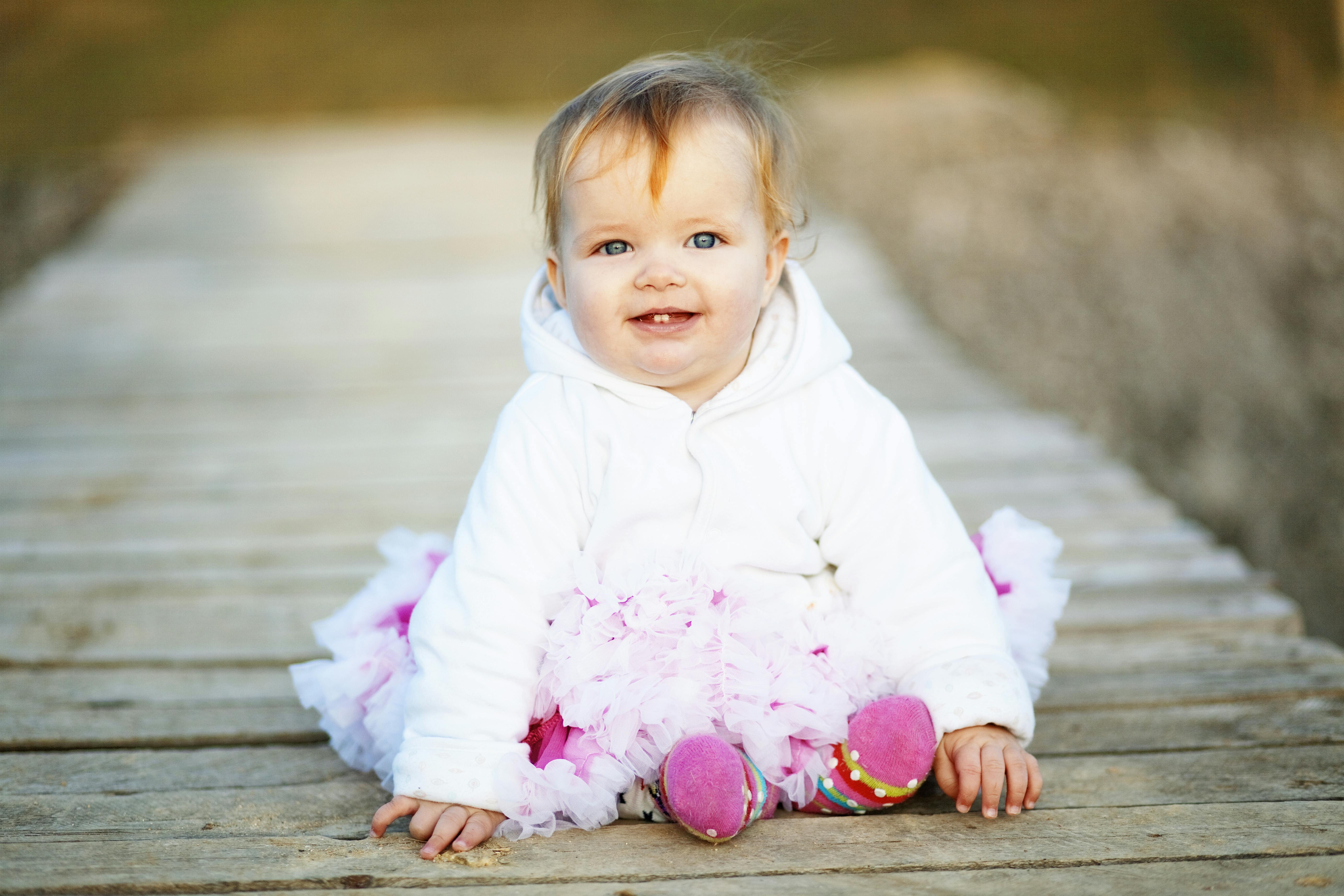 Redhead baby girl dock white sweater.jpg?ixlib=rails 3.0